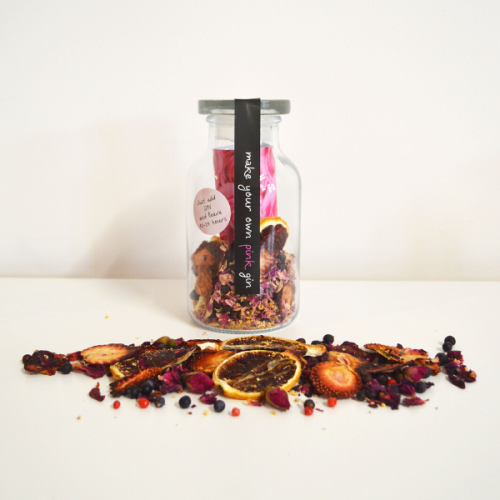 Glass bottle containing dried fruits and flowers